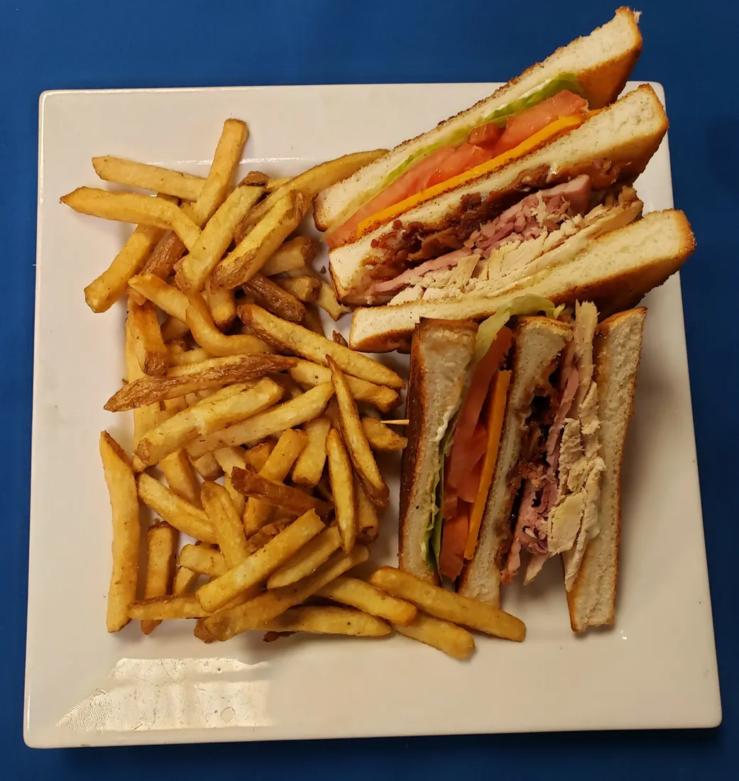 Clubhouse sandwich with turkey, ham and bacon, served with fries at Cheryl's Country Kitchen near Bayside, Airdrie