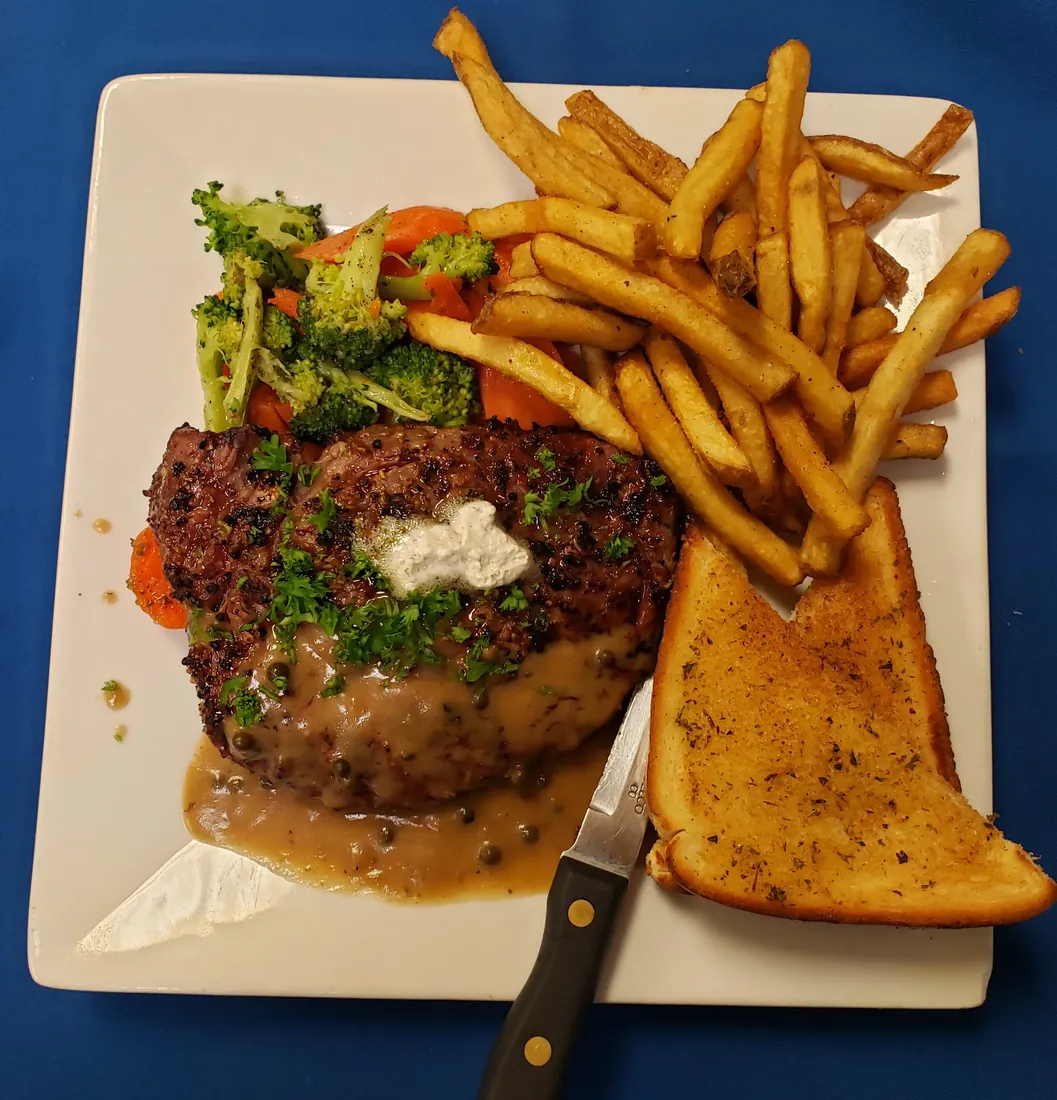 Char-grilled rib eye steak dinner with peppercorn sauce, fries and vegetables at Cheryl's Country Kitchen in Airdrie