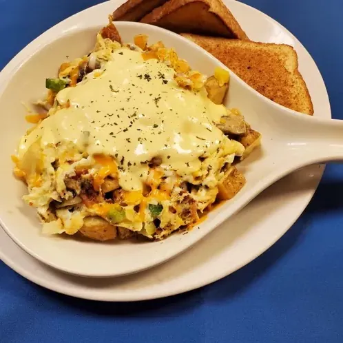 Country Skillet loaded with potatoes, eggs and cheese, served with toast