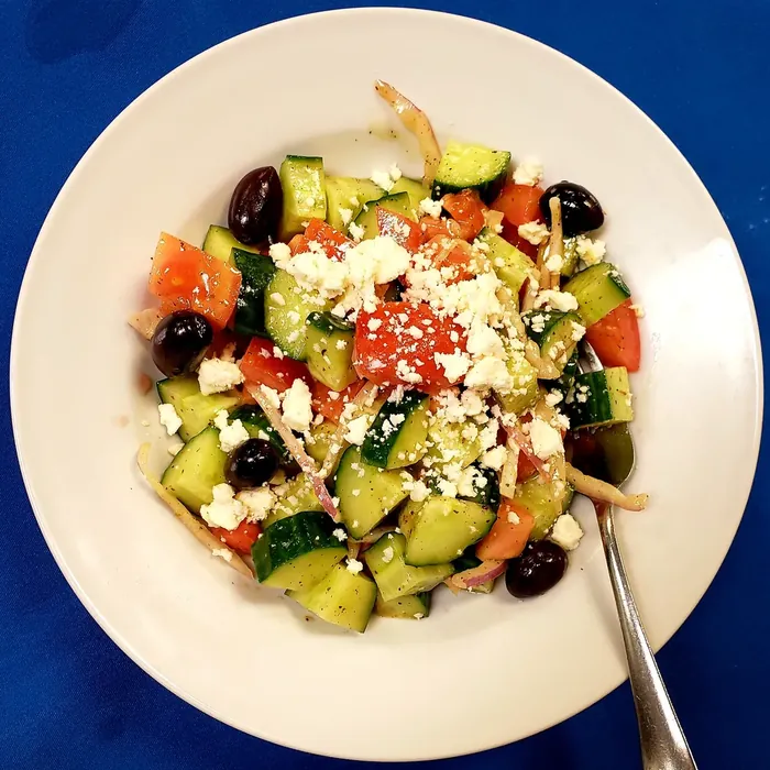 Greek salad with cucumber, tomato, red onion, kalamata olives and feta