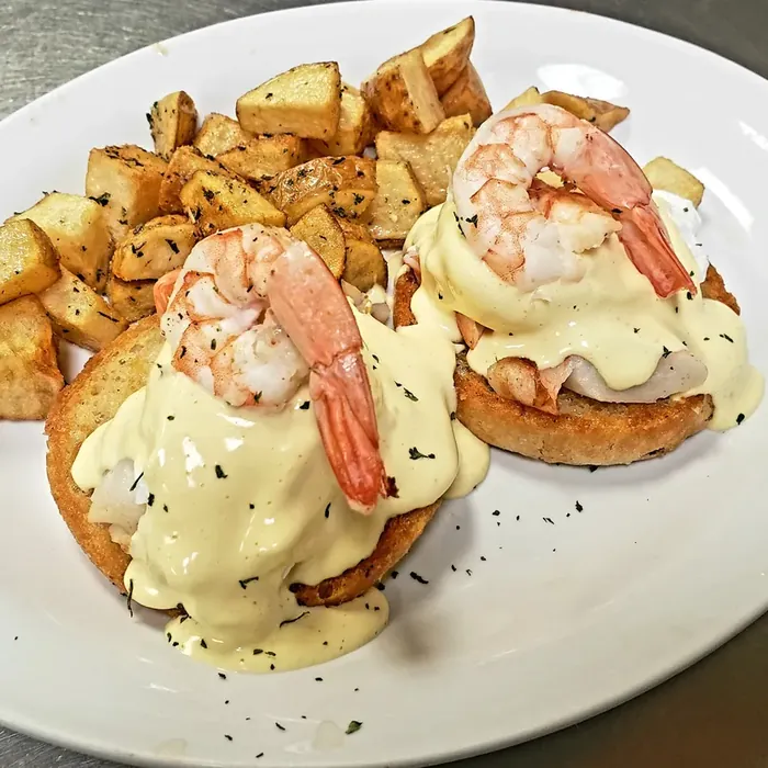 Seafood Benni topped with shrimp and hollandaise, served with hash browns