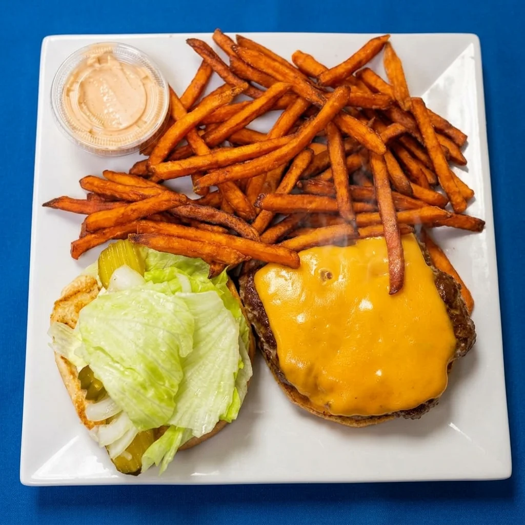 Cheeseburger with lettuce, tomato and red onion on a sesame bun at Cheryl's Country Kitchen near Bayside, Airdrie