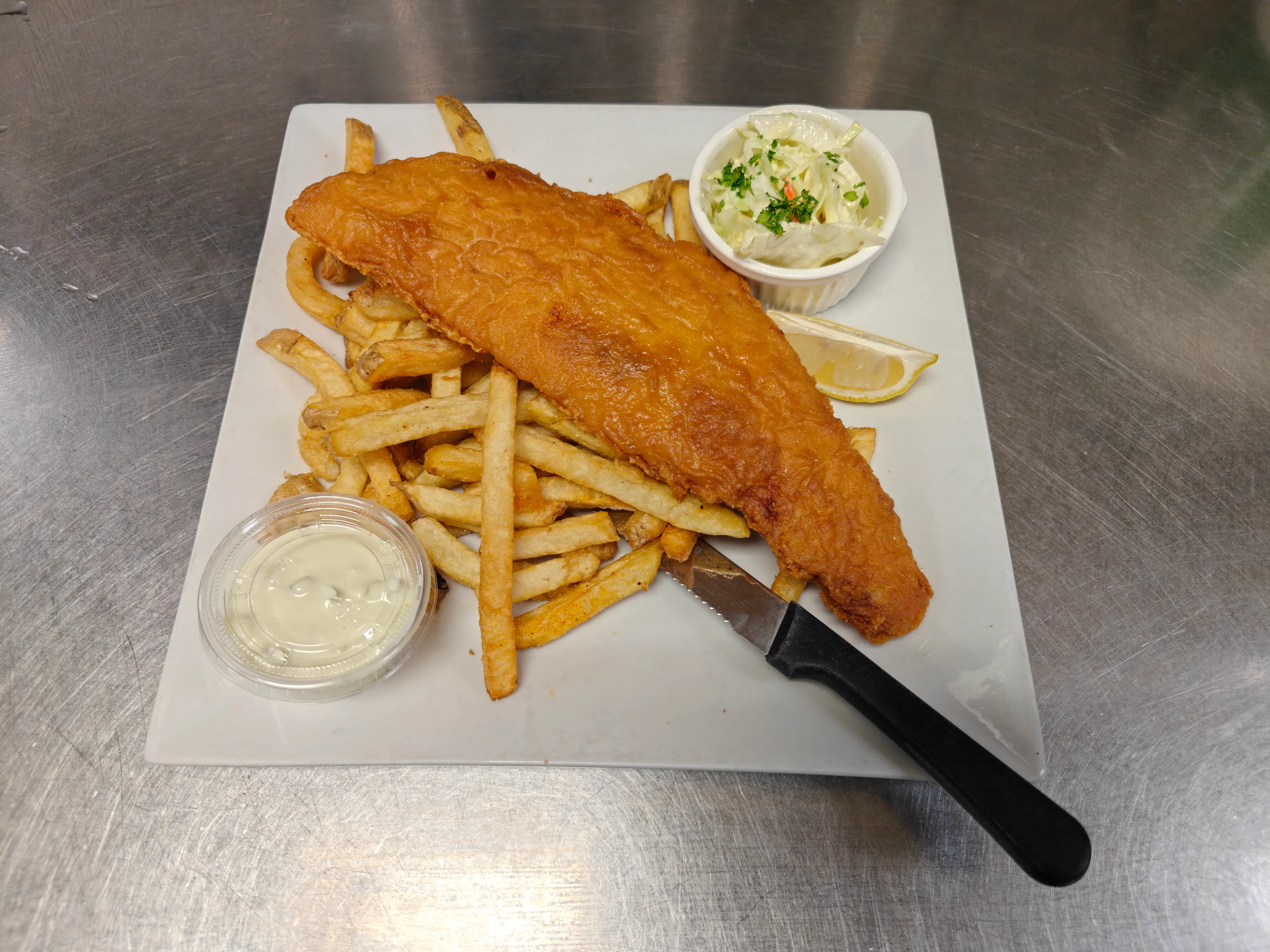 Golden battered haddock with fries, coleslaw and tartar sauce at Cheryl's Country Kitchen near Bayside, Airdrie