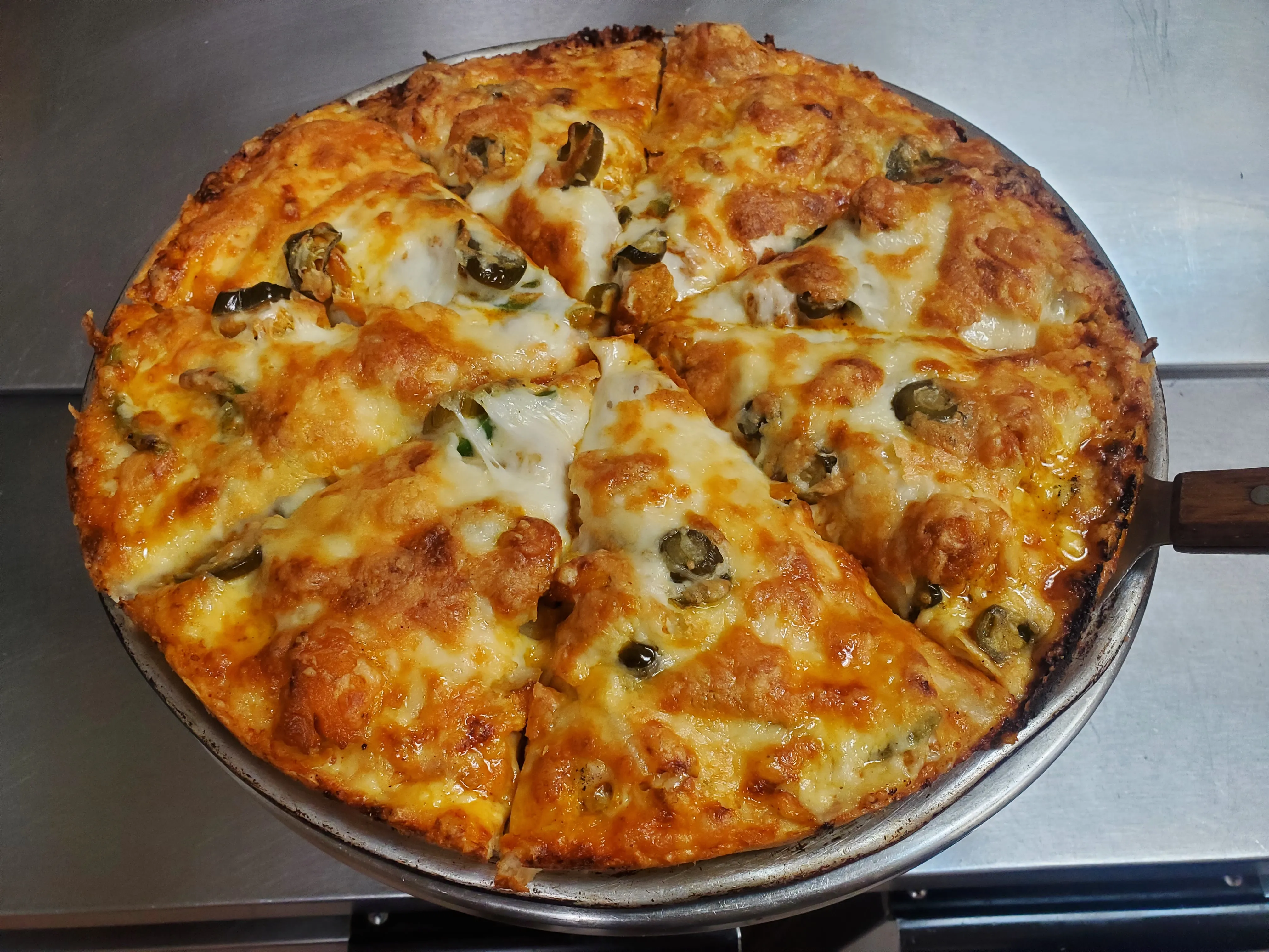 Hand-stretched pizza baked golden with bubbling mozzarella at Cheryl's Country Kitchen near Bayside, Airdrie