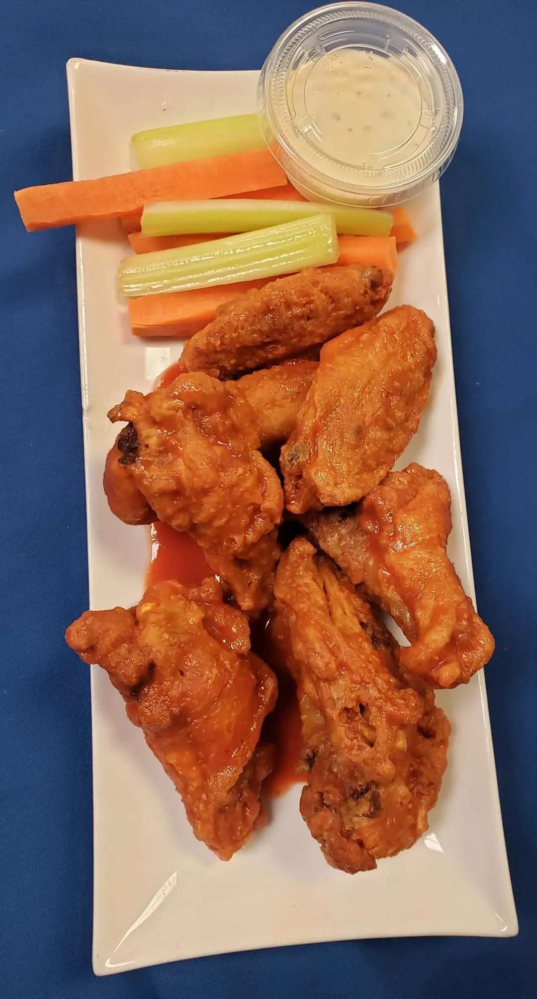 Saucy chicken wings with celery, carrots and ranch dip at Cheryl's Country Kitchen near Bayside, Airdrie